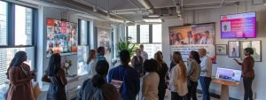 a vibrant urban office space filled with diverse professionals engaged in collaborative discussions around mental health resources, featuring bold posters and interactive displays promoting mental health awareness month 2025.